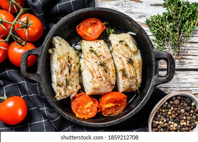 Fried Cod Fish Fillet With Spice In A Cast Iron Pan. White Background. Top View.