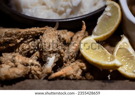 Fried crab fingers with lemon slices.