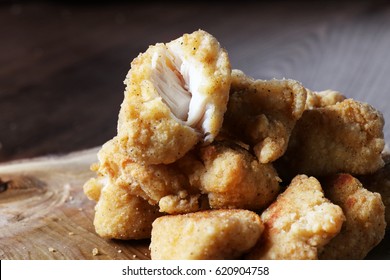 Fried Crispy Chicken Nuggets Tower On Wood. Close Up