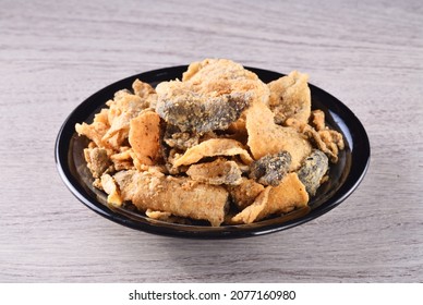 Fried Crispy Fish Skin On Black Plate    