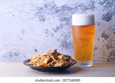 Fried Crispy Fish Skin On Black Plate    