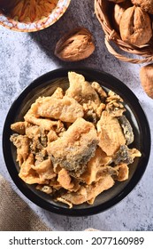 Fried Crispy Fish Skin On Black Plate    