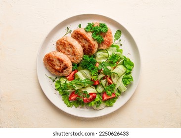 Fried cutlets, turkey, with vegetable salad, top view, no people,