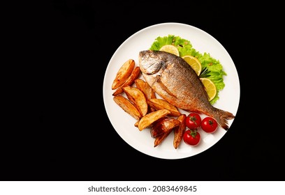 Fried Dorado Fish, With Potatoes, Top View, On A Black Background, No People,