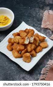 
Fried Dori Fish With Salted Duck Egg Yolk Sauce, Serverd On White Square Ceramic Plate.selected Focus