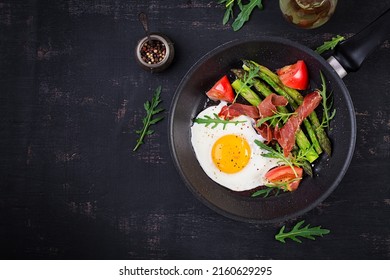 Fried Egg With Asparagus, Tomato And Bacon. Useful Breakfast. Top View, Overhead