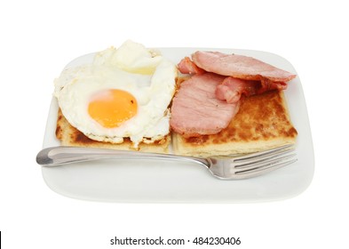 Fried Egg, Bacon And Irish Potato Bread With A Fork On A Plate Isolated Against White