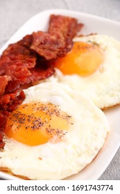 Fried Egg With Bacon On Plate.