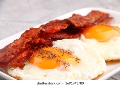 Fried Egg With Bacon On Plate.