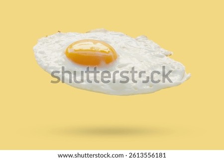 Fried egg float on yellow background