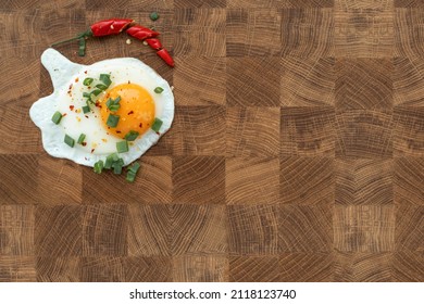 Fried Egg, Green Onion And Chili Pepper Served On Wooden Cutting Board With Beautiful Pattern. Morning Routine. Breakfast.