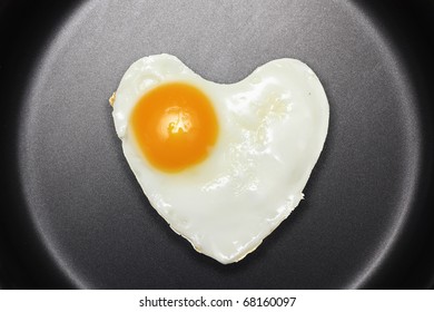 Fried Egg Like Heart On Frying Pan.