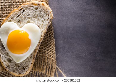 Fried Egg On Heart-shaped Slice Of Bread.