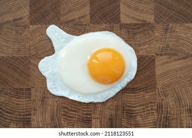 Fried Egg On Wooden Cutting Board. Morning Routine. Breakfast, Close-up. Minimalism Design