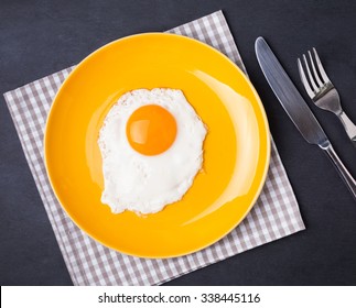 Fried Egg On The Yellow Plate, Top View