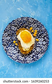 Fried Egg Sandwich With Pesto Sauce And Sweet Corn On Blue Background Flat Lay