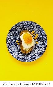 Fried Egg Sandwich With Sweet Corn And Pesto Sauce On Yellow Background Flat Lay