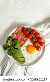 Fried Eggs With Bacon And Avocado,  And Cherry Tomatoes, Ketogenic Diet. Low Carb High Fat Breakfast. Healthy Food Concept         