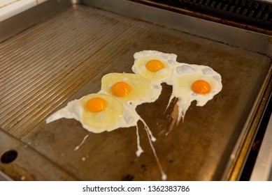 fried eggs on restaurants cooking top, breakfast for kitchen staff and employees