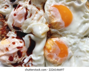 Fried eggs served with seasoning sauce or soy sauce. Healthy food for breakfast ideas to start the active morning. Food background theme. (close up, top view, space for text) - Shutterstock ID 2226146697