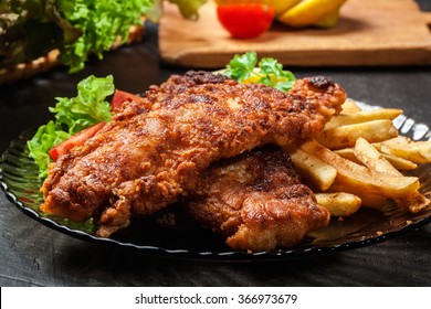 Fried fish in crispy batter with chips on a plate