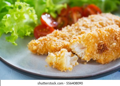 fried fish fillet with bread crumb and vegetable