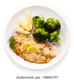 Fried Fish Fillet With Broccoli On White Background