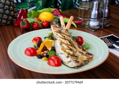 Fried Fish Garnished with orange  and Vegetables