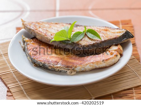 A fried fish on plate.
