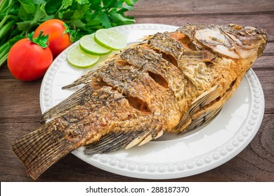 Fried Fish On Plate With Vegetables
