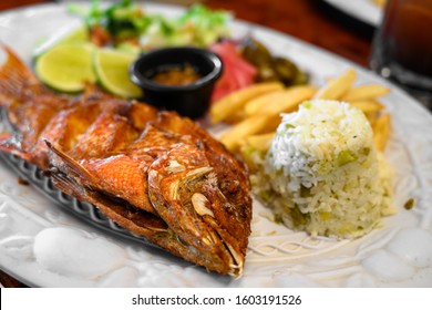 Fried Fish Platter In Mexico, With French Fries, Vegetables, Lime And Habanero Sauce