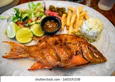 Fried Fish Platter In Mexico, With French Fries, Vegetables, Lime And Habanero Sauce