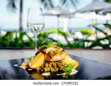 Fried fish with potatoes and salad on a white plate. Rrestoran - Powered by Shutterstock