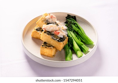 Fried Fish Served With Steamed Choi Sum.