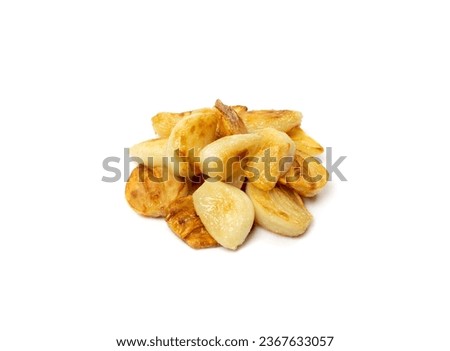Fried garlic cloves pile closeup isolated. Roasted grilled garlic clove group on white background top view