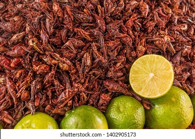 Fried grasshoppers (chapolenas) and lemon at a market, Mexico