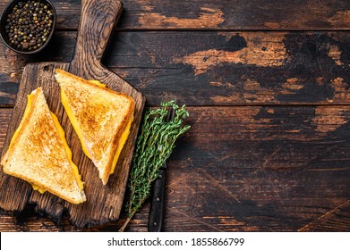Fried Ham And Melted Cheese Sandwich. Dark Wooden Background. Top View. Copy Space