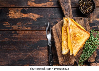 Fried Ham And Melted Cheese Sandwich. Dark Wooden Background. Top View. Copy Space