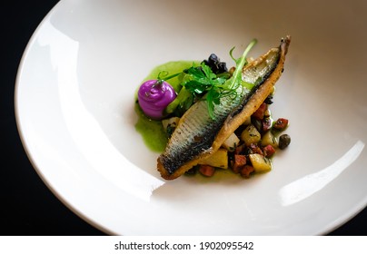 Fried Herring Filet With Potatoes, Purple Mayonnaise In Green Olive Oil On White Plate