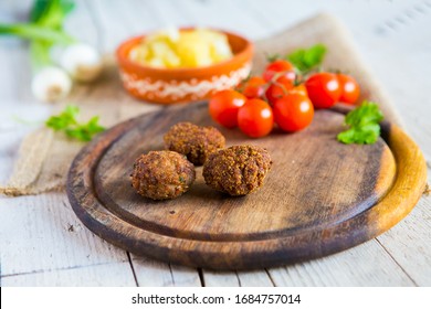 Fried Horse Meatballs With Potato Salat, Garlic, Tomatoes, Sweet Onions And Parsley