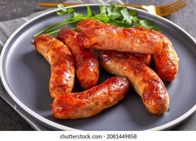 fried  juicy bangers on a plate on a concrete table,  top view, close-up