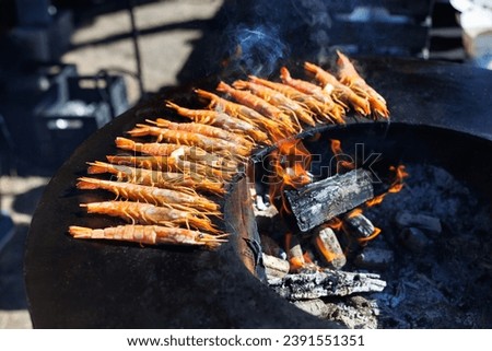 Fried king shrimps seafood by fire and BBQ Flames