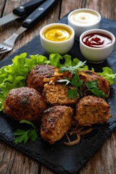 Fried Meatballs On Black Stony Plate On Wooden Table 