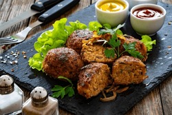 Fried Meatballs On Black Stony Plate On Wooden Table 