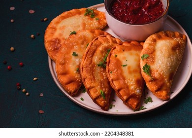 Fried mini pasties, with red sauce, top view, close-up, no people, selective focus, - Shutterstock ID 2204348381
