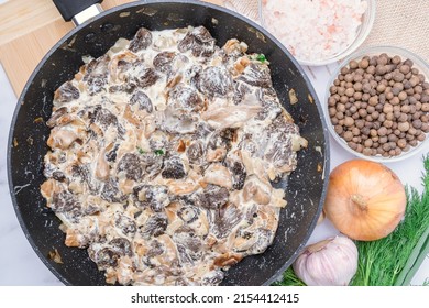 Fried Morel Mushrooms In Sour Cream Sauce In A Frying Pan