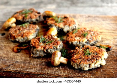 Fried mushroom cutlets decorated with dill on a wooden background. Agaricus recipe. Vegetarian and diet food - Powered by Shutterstock