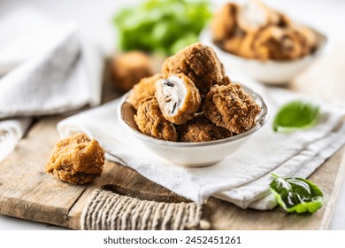 Fried mushrooms in breadcrumbs in a white bowl. Homemade crispy deep fried mushrooms.  - Powered by Shutterstock