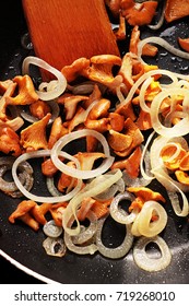 Fried mushrooms chanterelles with onion in oil