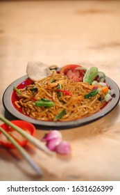 Fried Noodles With Dried Chilli,onion,pickels,tomatoes With Fish Cracker